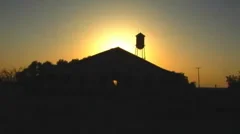Sunset Behind Old Farmhouse With Water Tower 1