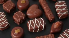 Closeup of chocolates in box rotates around