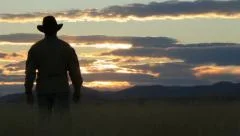 Cowboy Walking Toward Sunset (HD) c