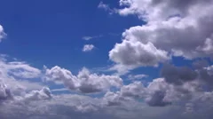 peaceful backlit time lapse clouds against a deep blue sky