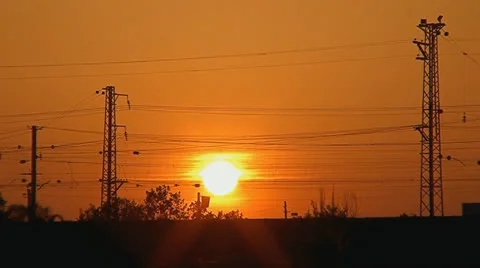 005 sunset of a sun above the line of electricity transmissions 1 min Stock Footage 25144345