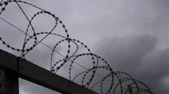 Barbed wire fence with moody sky timelapse