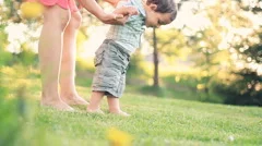 Baby first steps on grass, slow motion, dolly shot HD