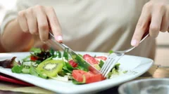 Woman eating salad, close up