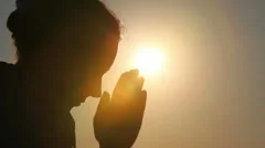 Silhouette of woman head, she is praying