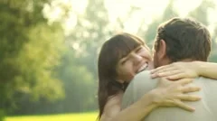 Woman hugs and kiss man, outdoors, slow motion
