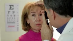 optometrist using an ophthalmoscope