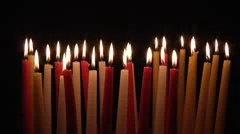 Group of Multicolored Candles on black background.