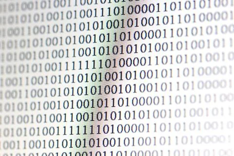 0,1, binary code on led computer monitor 写真素材