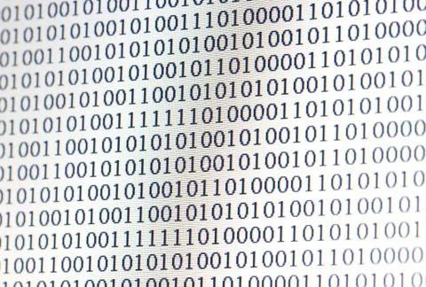 0,1, binary code on led computer monitor 写真素材