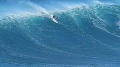 maui, hi - march 13: professional surfer rides a giant wave at the legendary