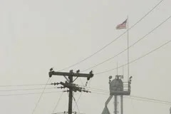 American Factory with flag on top of building in Small Town America