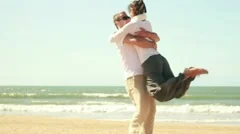 Young happy couple in love at the beach, slow motion HD