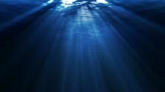 WATER BACKGROUND. Looping ocean waves, underwater. Light rays.