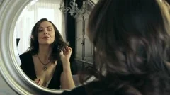 Women preen about mirror