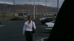 Blonde woman in a parking lot being stalked and followed by a predator
