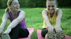 Portrait of two smiling women exercising in the park, tracking shot HD