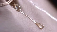 Stock footage close up - a drop of water flows down the female breast