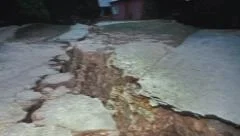 Earthquake rips ground apart, shaking the Earth with violent action.