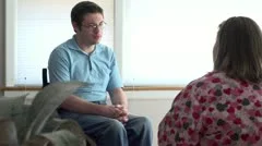 Man in wheelchair at home with nurse