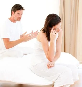 Angry couple having an argument sitting on their bed xkwx 30s,Mid Adult,Man,Caucasian,20s,Young Adult,Woman,Affronted,Annoyed,Argument,Bed,Bedroom,Bereaved,Bitter,Boyfriend,Couple,Depressed,Despairing,Despondent,Disconsolate,Dismal,Displeased,Distressed,Divorce,Exacerbated,Exasperated,Girlfriend,Gloomy,Glum,Heterosexual,Home,Husband,Indoors,Infuriated,Interiors,Irascible,Irate,Ireful,Irritable,Lovers,Low-spirited,Married,Melancholy,Morbid,Mournful,Offended,Pessimistic,Relationship,Resentful,Riled,Troubled,Unhappy,Valentine,Vexed,Wife,Adult