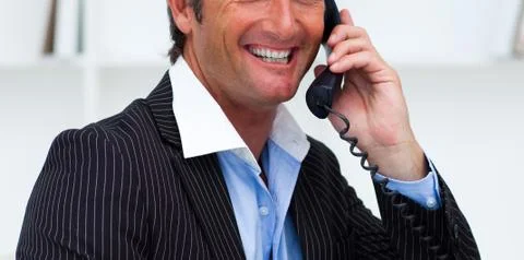 close-up of a smiling businessman talking on phone in the office xkwx background,business,businessman,call,caucasian,cell,collar,communicate,communication,computer,concept,confident,conversation,corporate,desk,executive,expression,face,hand,handsome,holding,isolated,male,man,manager,mobile,modern,office,people,person,phone,portrait,power,professional,service,shirt,smiling,speaking,studio,success,suit,support,talking,team,telephone,tie,white,work,worker
