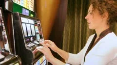woman presses buttons on slot machine and rejoices to prize