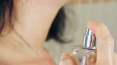 Woman Spritzing Perfume on Her Neck