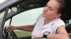 Frustrated young woman stuck in a traffic jam HD