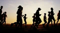 Silhouette runners on racing track  