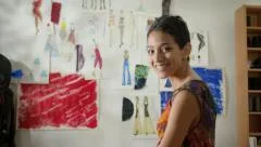 Portrait of happy successful hispanic young woman working as fashion designer