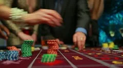 People placing their bets on roulette table