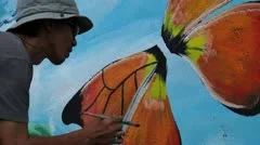 Mural painter draws butterfly