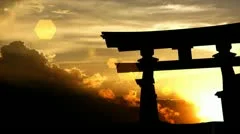 Japanese torii gate with beautiful sunset as background.
