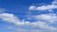 White clouds flying on blue sky. Timelapse.