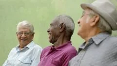 Happy seniors, portrait of three old men laughing and talking in park