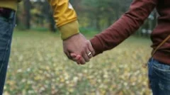 Boy and girl walking in the park holding hands