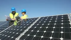 engineers working on solar panels plant