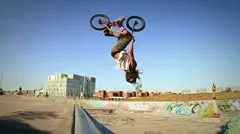 BMX Bicycle Back Flip Slow Motion in Graffiti Covered Skateboard Park