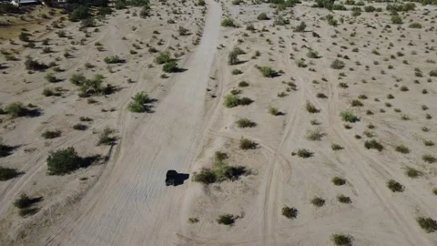 02 Desert Aerial Fly Over Off Roading Vehicle in sandy terrain Stock Footage 323774084