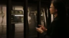 Woman Using Smartphone on Active Subway Platform