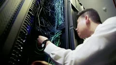 IT engineer working on server wiring in a data centre