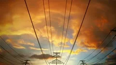 Electricity pylons and power lines industry metal construction wires sun and sky