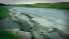 Earthquake rips road apart, shaking the Earth with violent action.