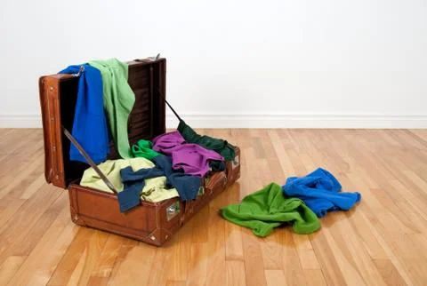 Leather  suitcase  on  a  wooden  floor  in  an  empty  room,  full  of  colorful  clothing. xkwx apparel,  bag,  baggage,  blue,  brown,  classic,  clothes,  clothing,  colorful,  colour,  colourful,  excess,  fabric,  fashion,  floor,  full,  garment,  green,  hardwood,  holiday,  journey,  leather,  luggage,  material,  messy,  multicolored,  nobody,  old,  old  fashioned,  old-fashioned,  open,  overfilled,  packed,  parquet,  retro,  room,  suitcase,  textile,  too  much,  tourism,  travel,  trip,  vacation,  vintage,  wall,  wear,  white,  wooden