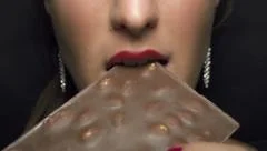 SLOW MOTION: Woman eating chocolate