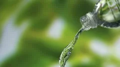 Water pouring from a clean plastic water bottle,