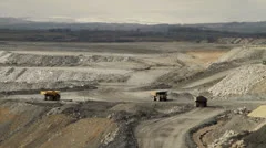 quarry with trucks exporting stones