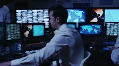 Security personnel working in system control room.