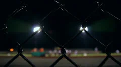 Football Stadium Behind Fence at Night